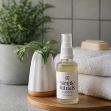 Load image into Gallery viewer, Bottle of 'Simple Rituals' cleanse on a wooden tray with towels and a plant in the background